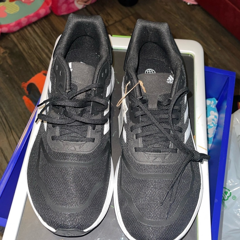 BRAND NEW Addidas Duramo 10 wide men’s running shoes. They are size 11 1/2.